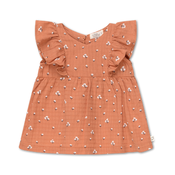 abito in cotone biologico smanicato per bambina, firmato My Little Cozmo, a trama floreale su fondo terracotta. Tessuto in mussola di cotone, scollo tondo, taglio svasato, apertura posteriore tramite bottoni altezza collo, balze sulle spalle