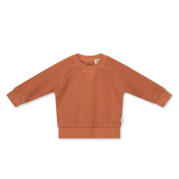 Felpa bambini in cotone biologico, firmata My Little Cozmo, in tonalità terracotta. Tessuto testurizzato, girocollo con inserto a V, maniche lunghe raglan, chiusura a bottoni nel retro ad altezza collo