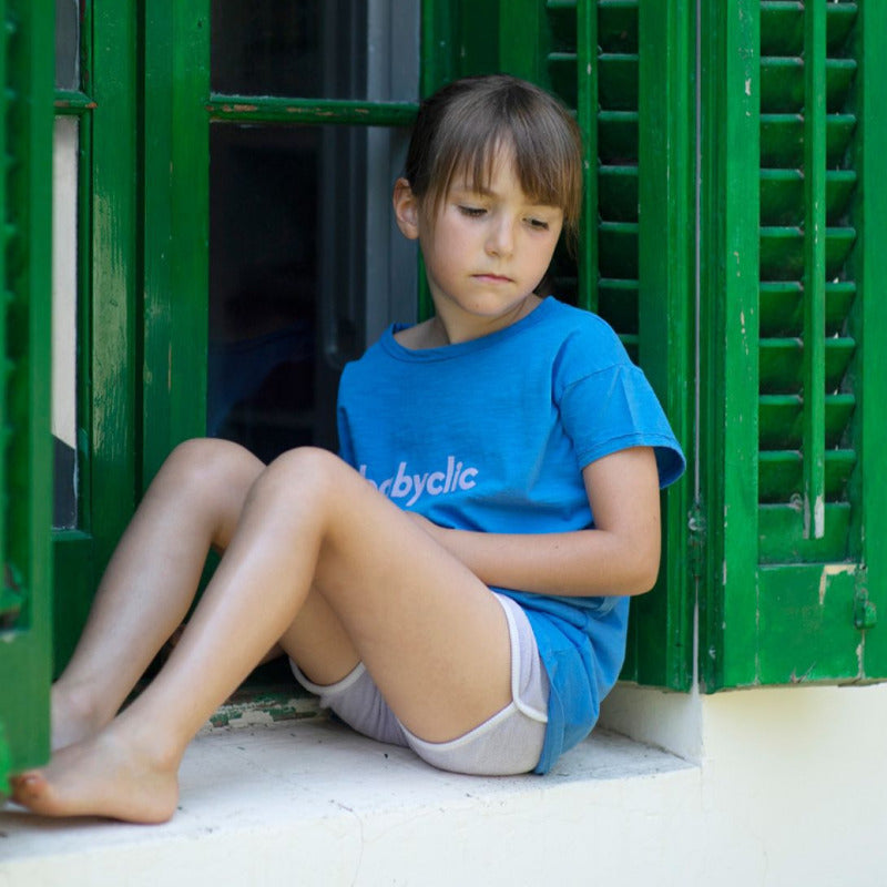 Una bellissima t-shirt per i vostri bambini in morbido e fresco cotone biologico a manica corta, con il logo babyclic su fondo blu elettrico. Apertura lungo spalla tramite bottoncini, finiture con bordi grezzi, tintura in capo.