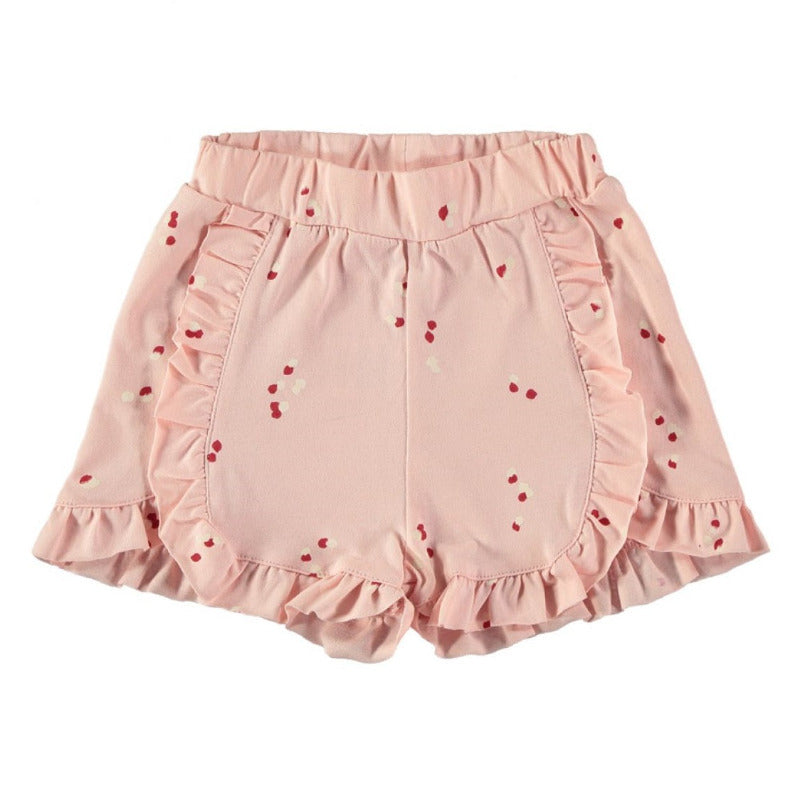 Grazioso shorts per la vostra bambina in cotone biologico con una trama a petali su fondo rosa. Elastico in vita, dettagli a volants frontalmente e sugli orli.