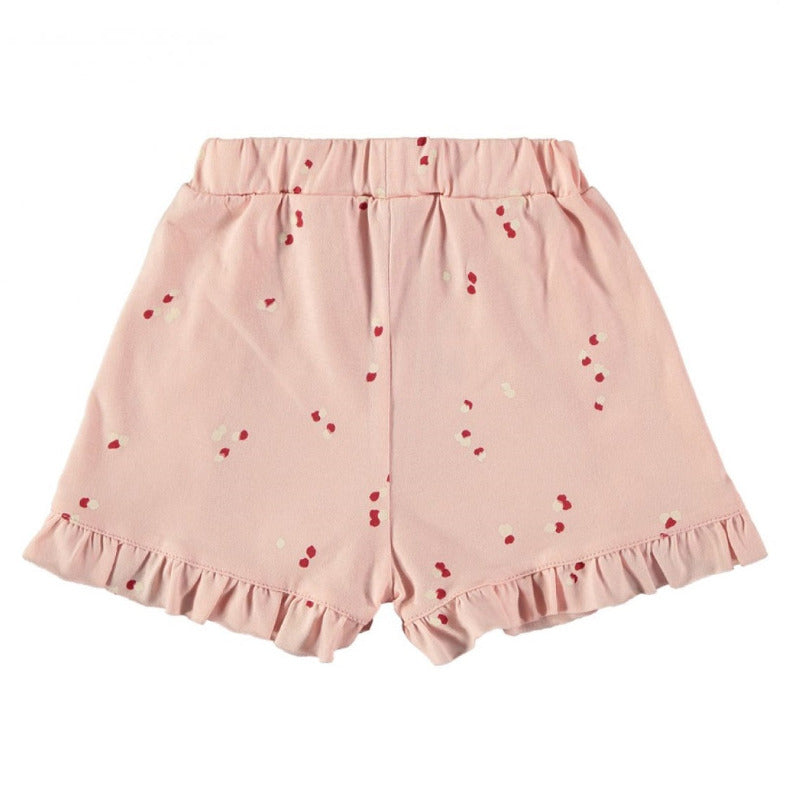 Grazioso shorts per la vostra bambina in cotone biologico con una trama a petali su fondo rosa. Elastico in vita, dettagli a volants frontalmente e sugli orli.