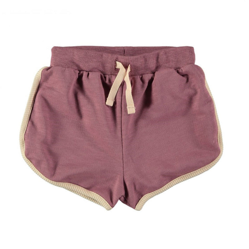 Grazioso shorts per la vostra bambina in cotone biologico in tonalità borgogna. Elastico in vita, chiusura a cordoncino, profili cordati.