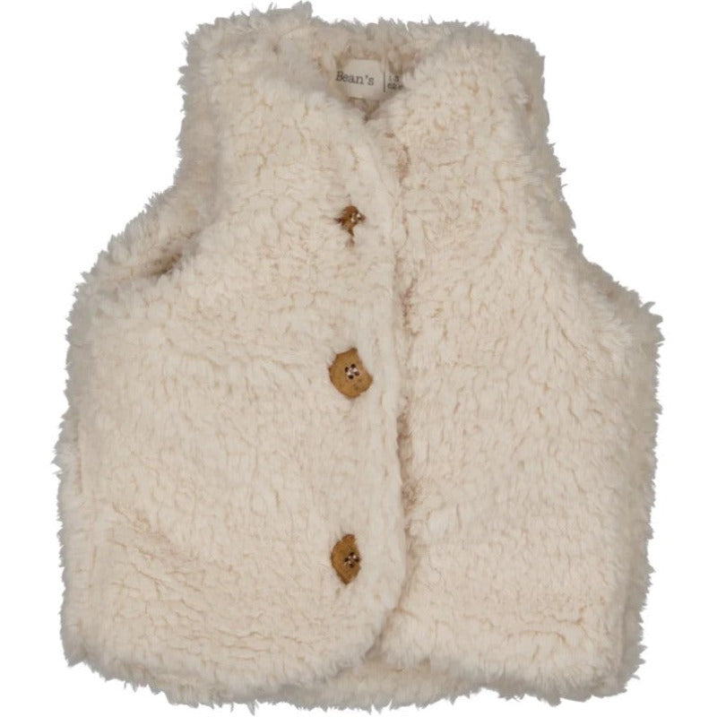 Una bellissima giacca gilet sherpa con soffice superficie bouclè, perfetta per tenere al caldo il corpo dei vostri bambini. Capo realizzato in morbidissima pelliccia ecologica, è perfetta da essere indossata sopra una t-shirt, una felpa o un abito. I borttoni sono realizzati con materiali riciclati e bioresine.